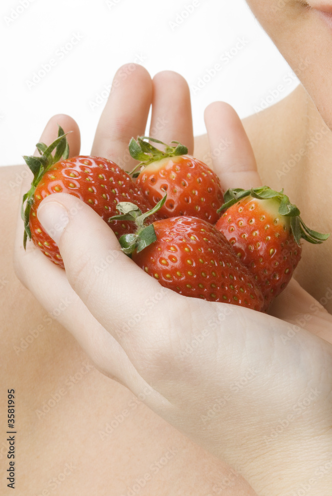 Obraz premium close up of a hand with strawberry fruit