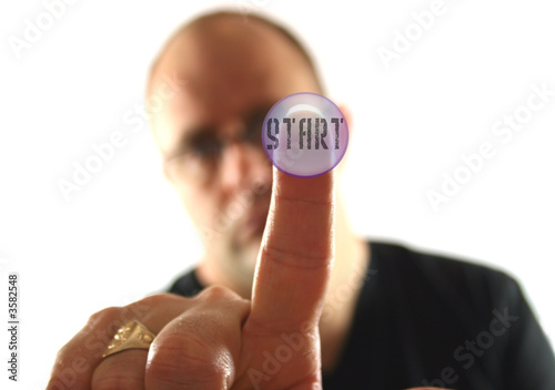 Man Pressing the Start Button.