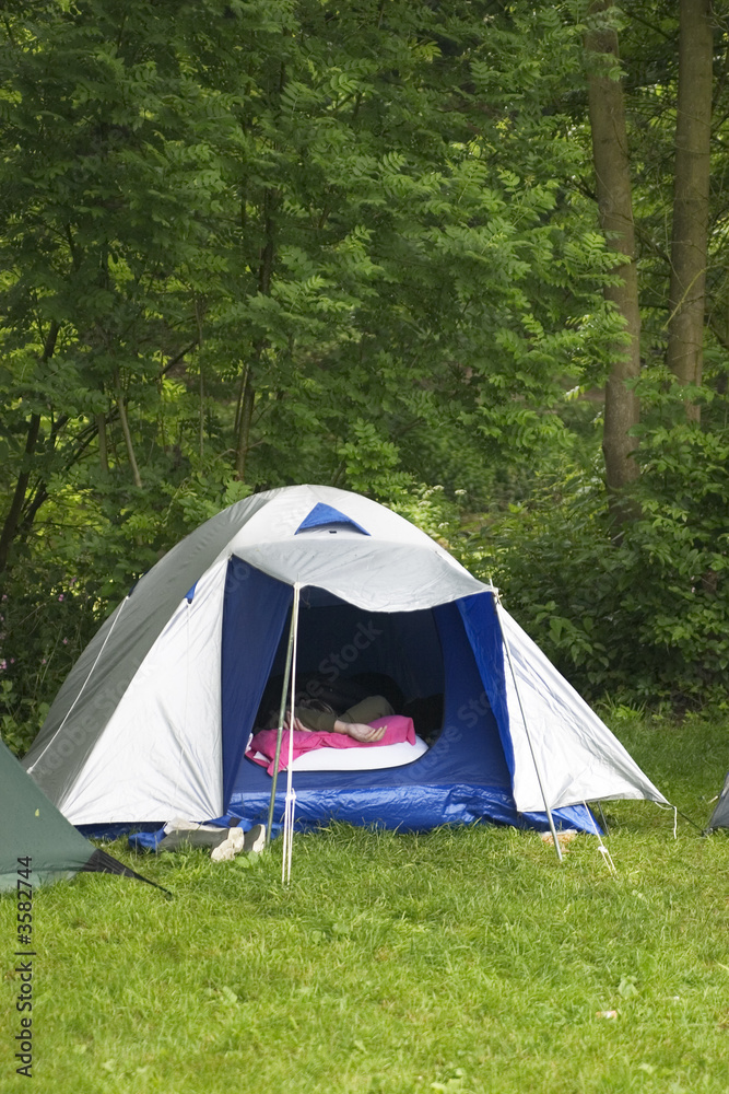 someone sleeping in a tent on a campingsite