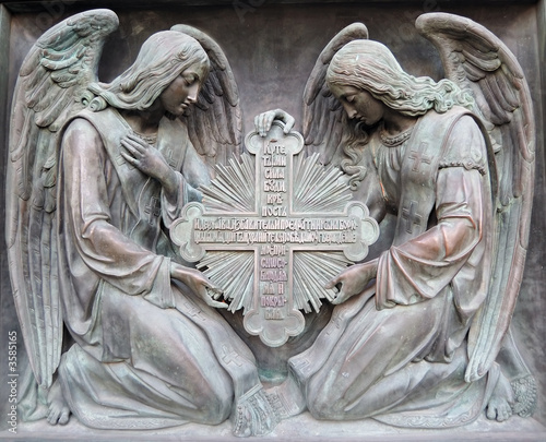 Bas-relief. Two angels hold cross.