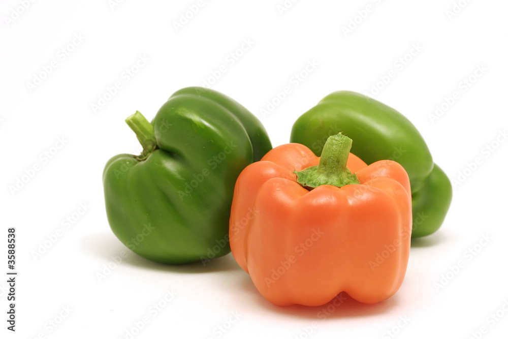 Green and orange bell peppers on white background Green and orange bell peppers on white background