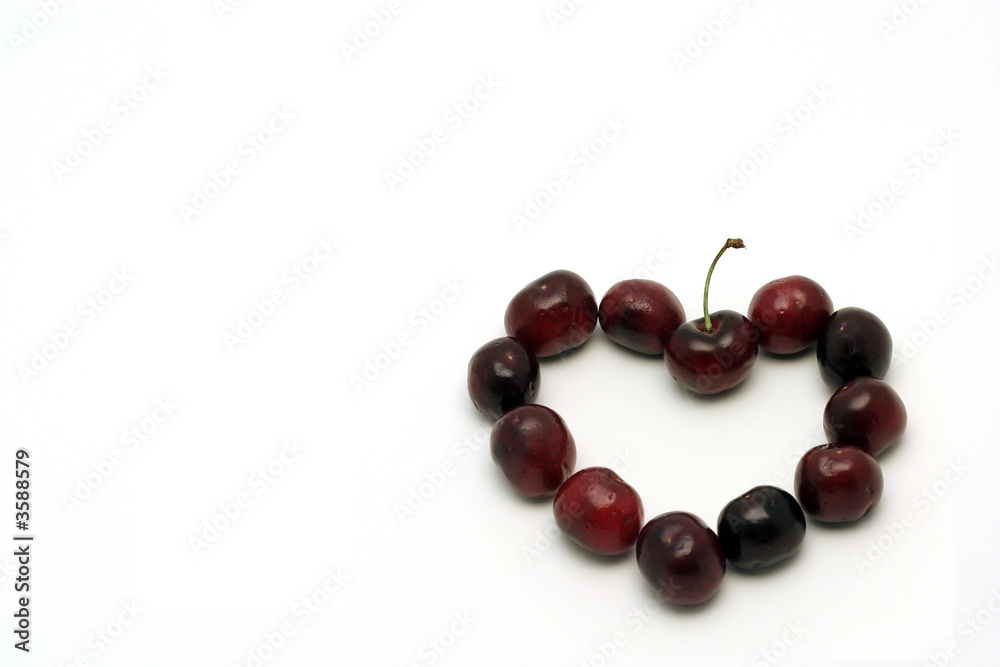 Heart made with deep red cherries, isolated on white Heart made with deep red cherries, isolated on white
