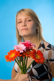 the woman and bouquet of flowers on blue background