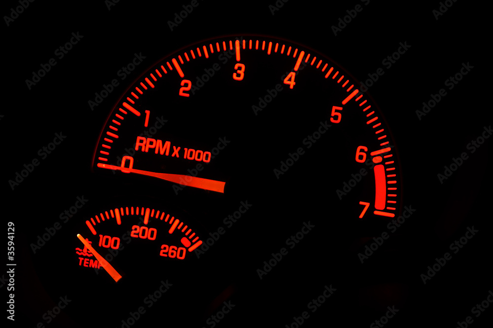 A red tachometer and temperature gauge. A red tachometer and temperature gauge.