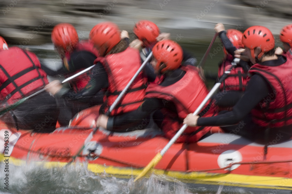 A red rafting team in action on whitewater. A red rafting team in action on whitewater.