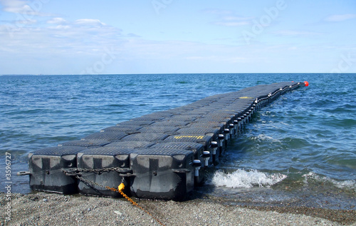 Floating Black Dock in choppy Blue Water