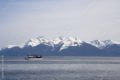 Snow capped mountains in the distance taken from the water