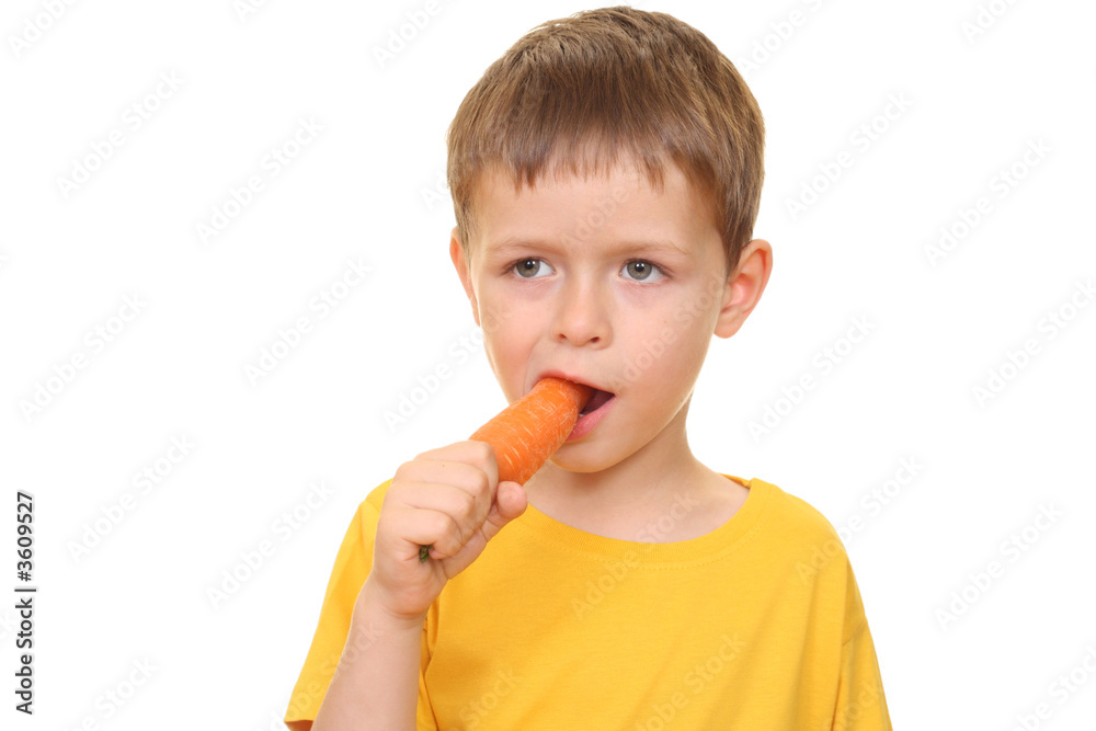 five years old boy eating fresh carrot isolated on white five years old boy eating fresh carrot isolated on white
