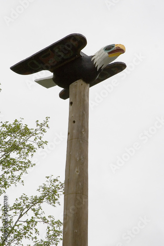 Eagle on top of  totem pole of Saxman Nature Village Ketchikan photo