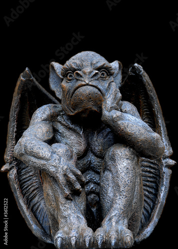 Scary looking Gargoyle sitting inside his wings