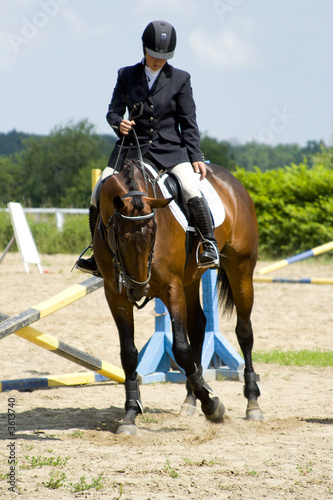 girl on a horse show jumping competition