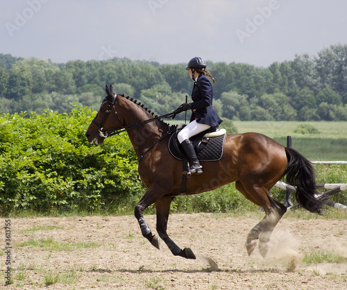 girl on a horse show jumping competition © konkar