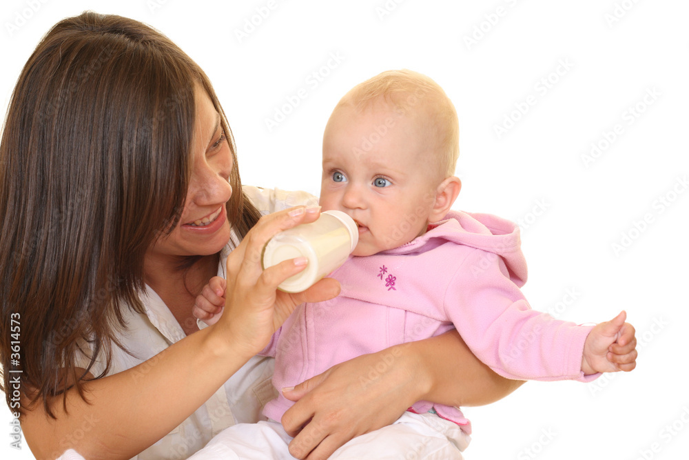 mother and 8 months baby girl with bottle of milk