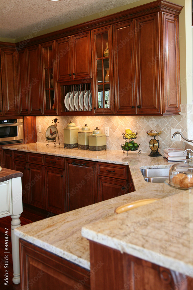 Naklejka Modern kitchen with cherry cabinets and granite counter tops