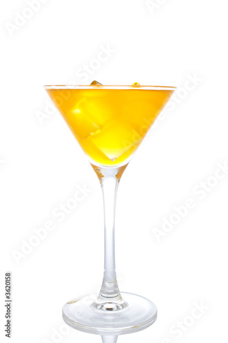 A glass of fresh orange cocktail reflected on white background