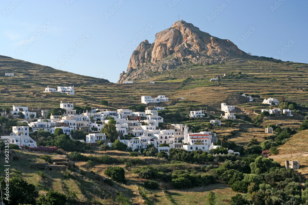 A typical Greek island village under a rock in Tinos island