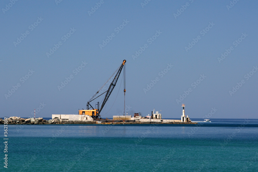 A crane on a pier, while working