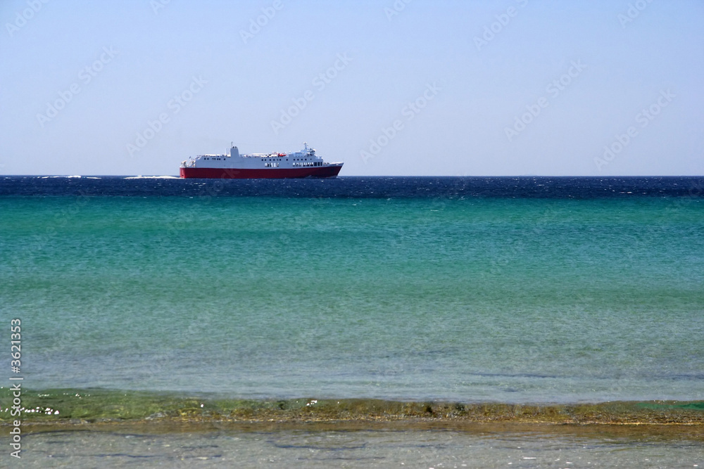 A ferry boat - seen from the beach - sailing to its destination A ferry boat - seen from the beach - sailing to its destination