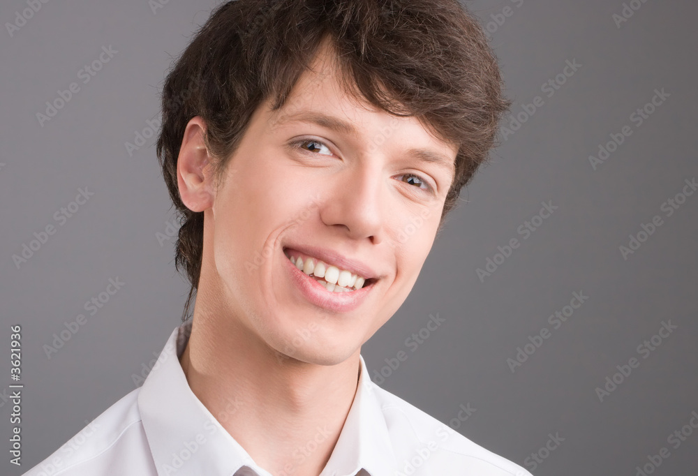 Young businessman smiling portrait isolated on gray Young businessman smiling portrait isolated on gray