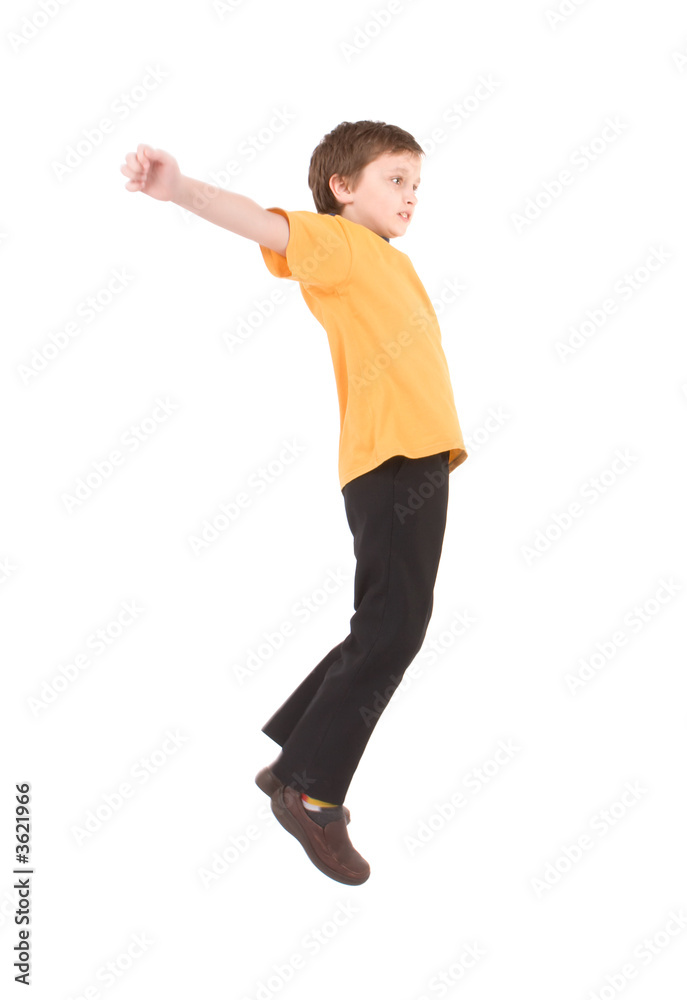 Young boy jumping up isolated on white
