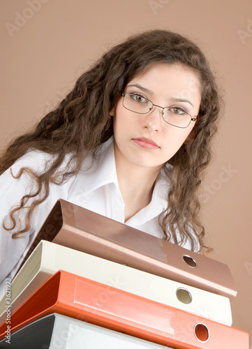 Businesswoman with files isolated on beige
