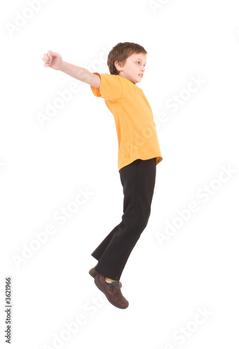 Young boy jumping up isolated on white