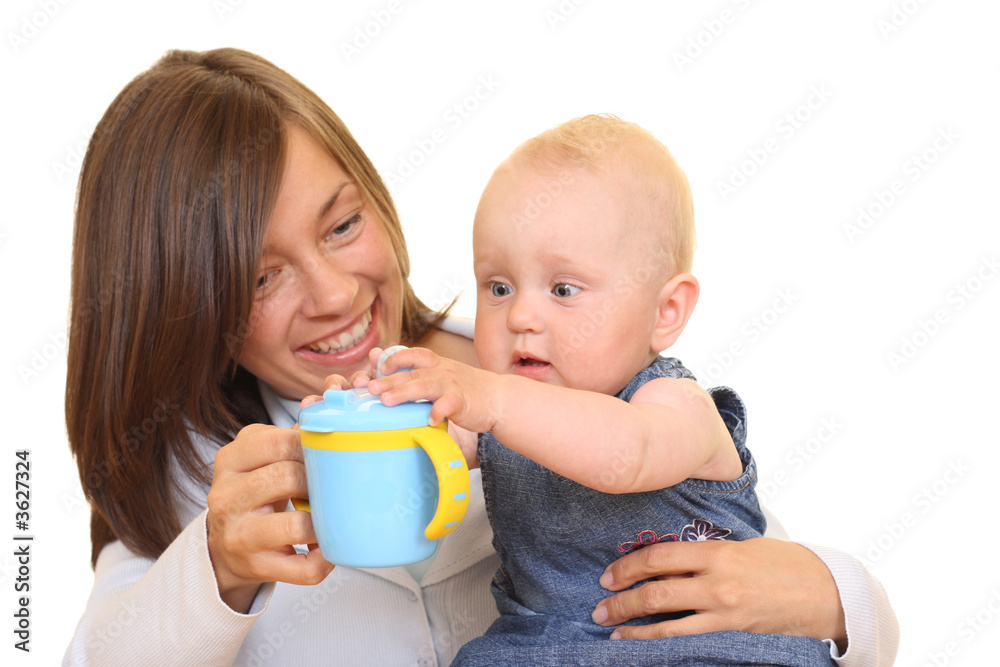 mother and 8 months baby girl with baby cup isolated on white mother and 8 months baby girl with baby cup isolated on white