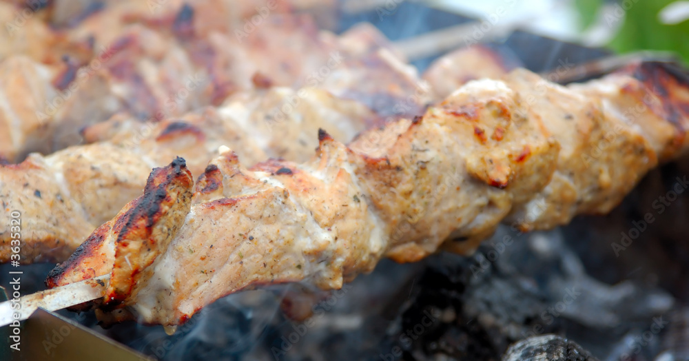 Kebabs cooking over a charcoal fire Kebabs cooking over a charcoal fire