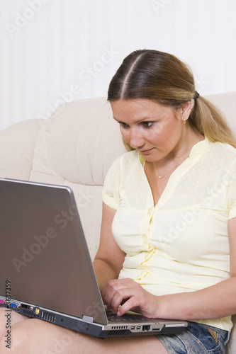 young pretty woman working at laptop computer