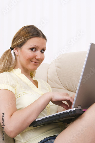 young pretty woman working at laptop computer