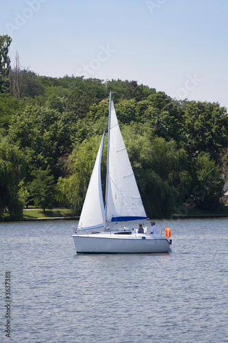 Relaxing by sailing with a little pleasure yach on a lake