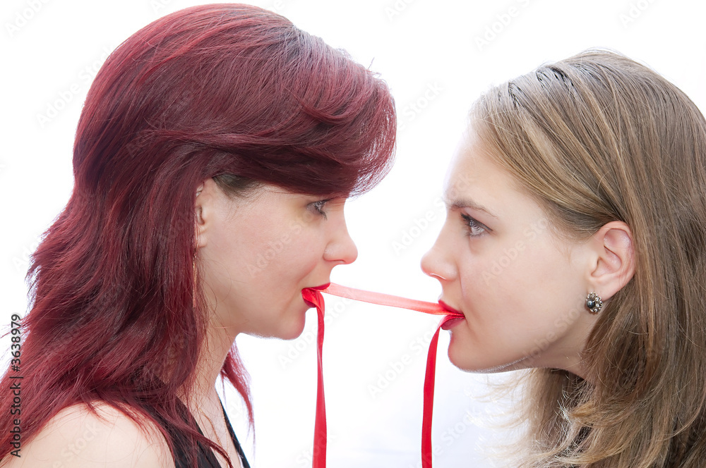 Two girls pulling a red tape Stock Photo | Adobe Stock