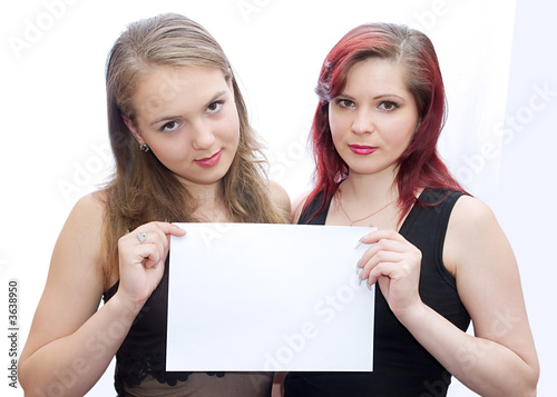 Two girls hold a sheet of paper