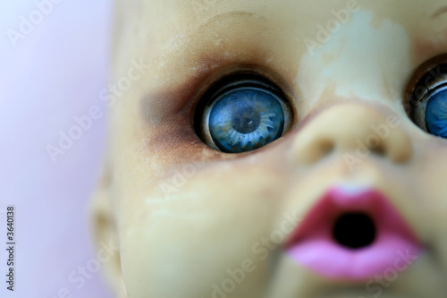 An extreme close up of a doll's face with shalow depth of field photo