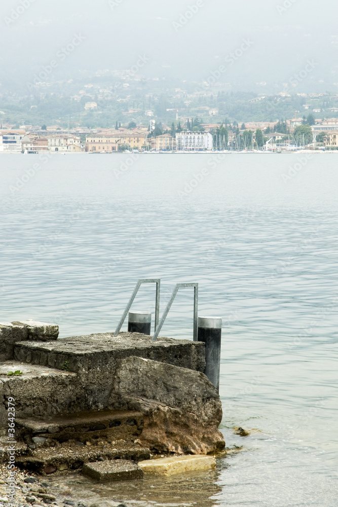 a pier from stones in lake Garda