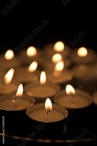 set of candles all lit over black background