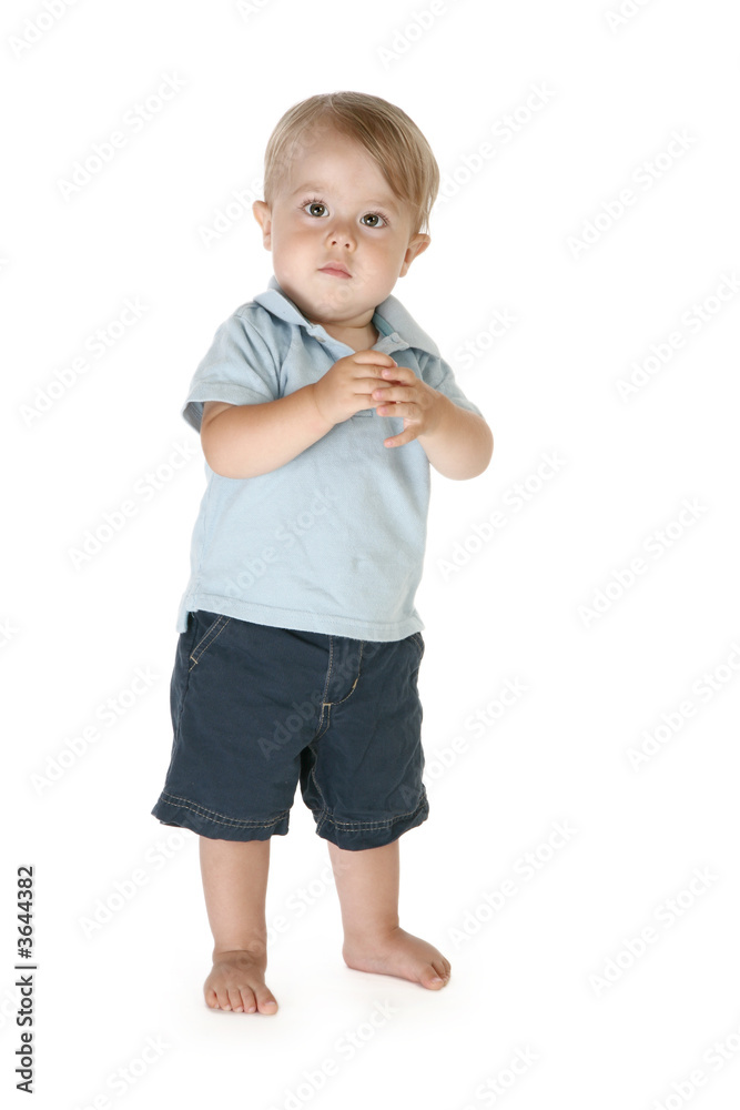 Boy of fifteen months standing barefoot over white background. Boy of fifteen months standing barefoot over white background.