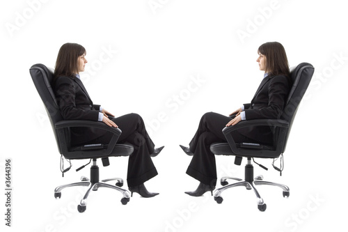 Businesswoman sitting on the chair with mirror image 