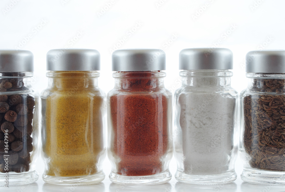 Five spice jars in a row on white background.. Five spice jars in a row on white background..