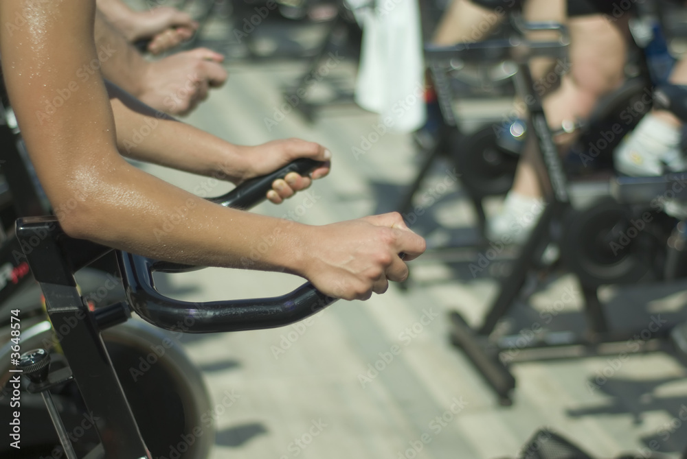 A group of people doing exercise with spinning bycicle A group of people doing exercise with spinning bycicle