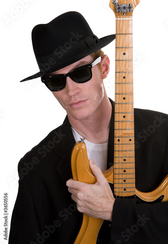 A Guitar Player Dressed In Black Posing