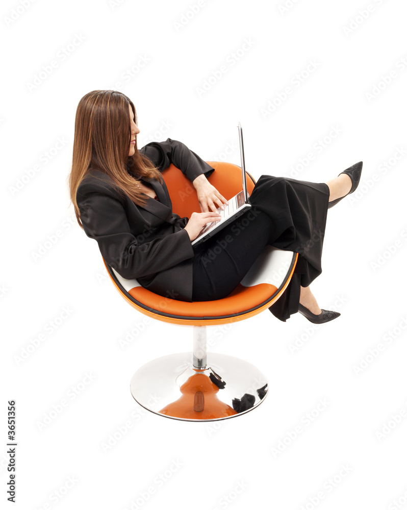 Fototapeta premium businesswoman with laptop in orange chair over white