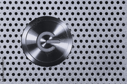Power Button on Metal Hole Background.