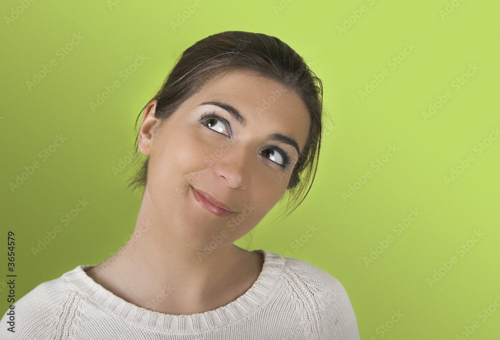 Fototapeta premium Portrait of a young woman on a green background