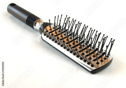 Black hairbrush on white background