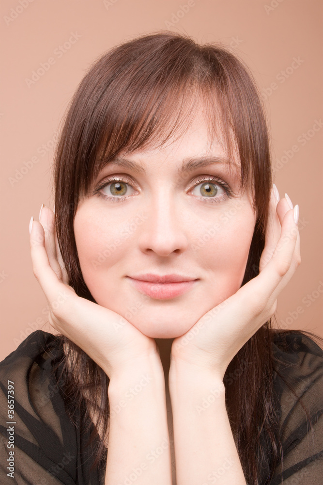 Woman in black portrait isolated on beige background Woman in black portrait isolated on beige background
