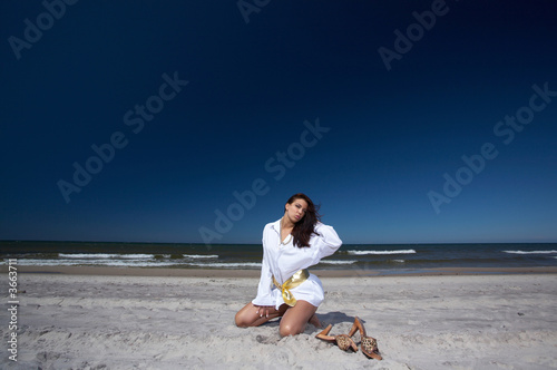 20-25 years old Beautiful Woman on the beach  wearing shirt