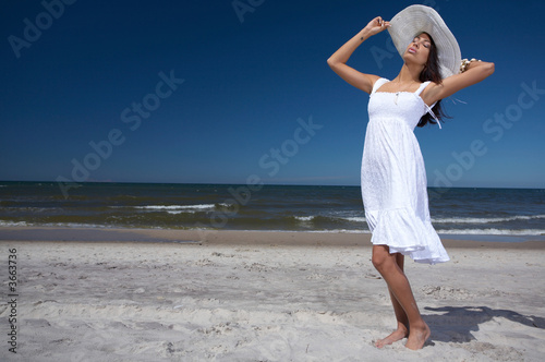 20-25 years old Beautiful Woman on the beach, wearing hat