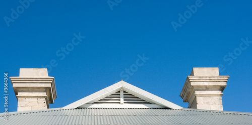 roof with tin and chimney with view to blue sky