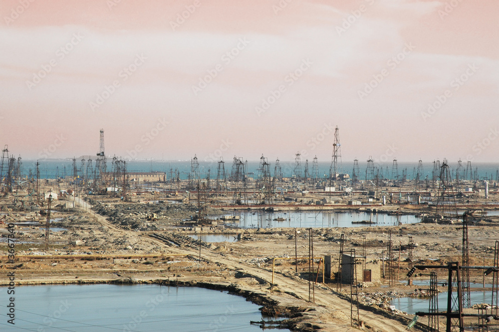Many oil derricks on the shore near Baku, Azerbaijan